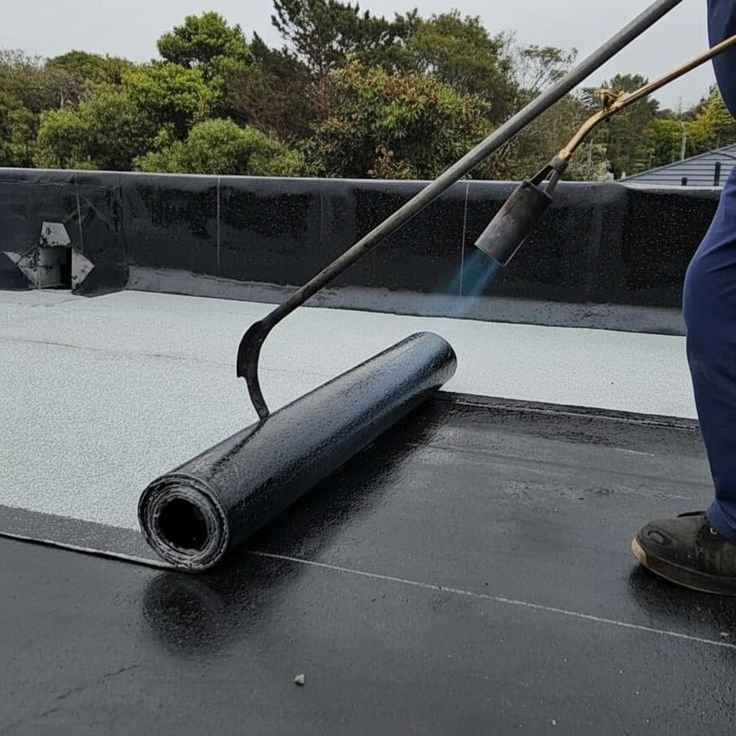 Crew applying waterproof membrane